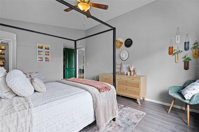 bedroom with lofted ceiling, ceiling fan, and hardwood / wood-style flooring