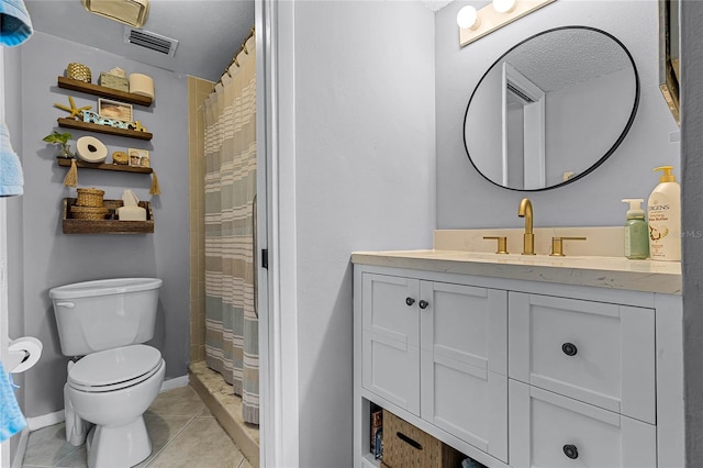 bathroom featuring vanity, tile patterned flooring, toilet, and curtained shower