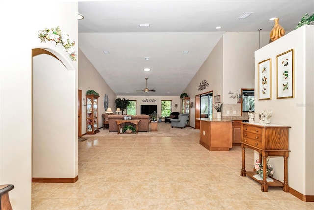 living room with ceiling fan and high vaulted ceiling