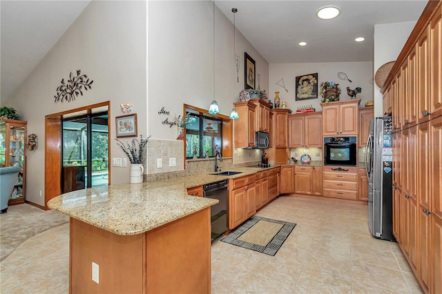 kitchen with light stone countertops, sink, kitchen peninsula, decorative backsplash, and black appliances