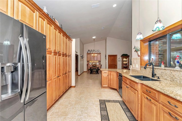 kitchen featuring stainless steel fridge, tasteful backsplash, sink, hanging light fixtures, and lofted ceiling