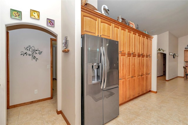 kitchen with stainless steel fridge and light tile patterned floors