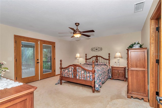 bedroom featuring ceiling fan, light carpet, access to outside, and french doors