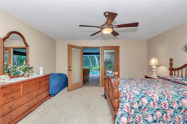 carpeted bedroom with french doors, a textured ceiling, access to outside, and ceiling fan