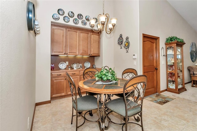 tiled dining space with high vaulted ceiling and a notable chandelier