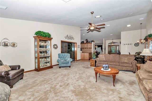 living room featuring carpet flooring and ceiling fan with notable chandelier