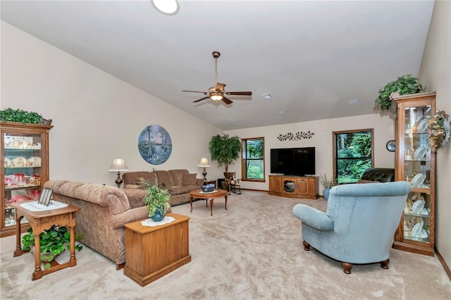 living room with light carpet, ceiling fan, and vaulted ceiling