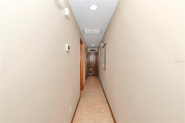 hall featuring light tile patterned floors