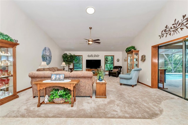 carpeted living room with ceiling fan and lofted ceiling