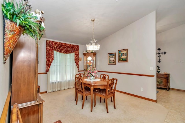 tiled dining area featuring a chandelier and lofted ceiling