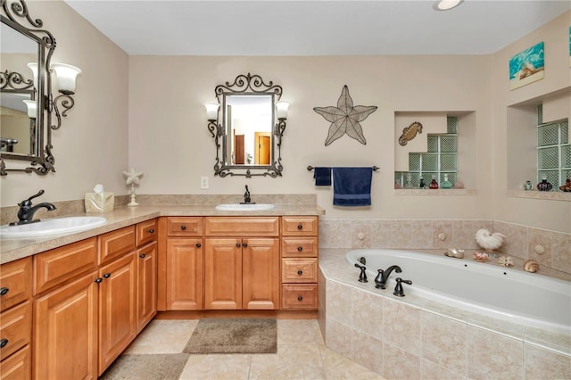 bathroom featuring tile patterned flooring, vanity, and tiled bath