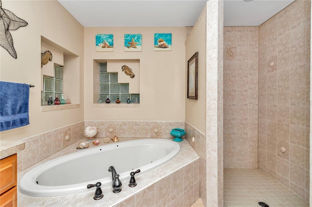 bathroom featuring vanity and shower with separate bathtub