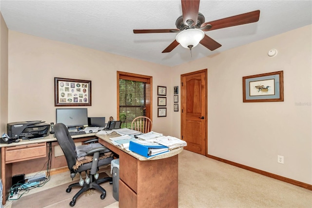 carpeted office space with ceiling fan