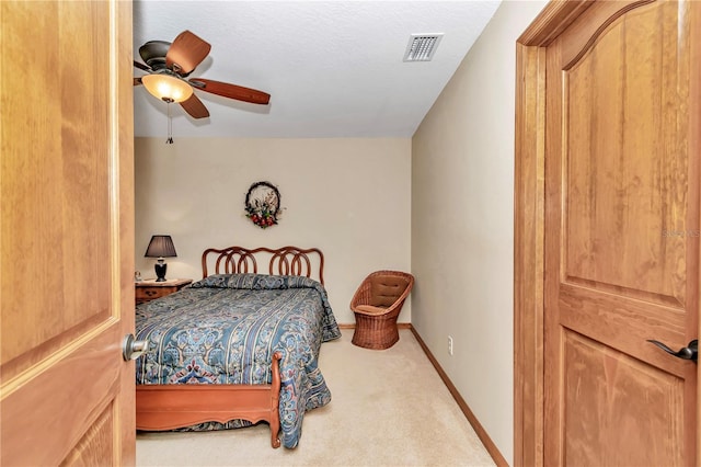 bedroom with ceiling fan and light colored carpet