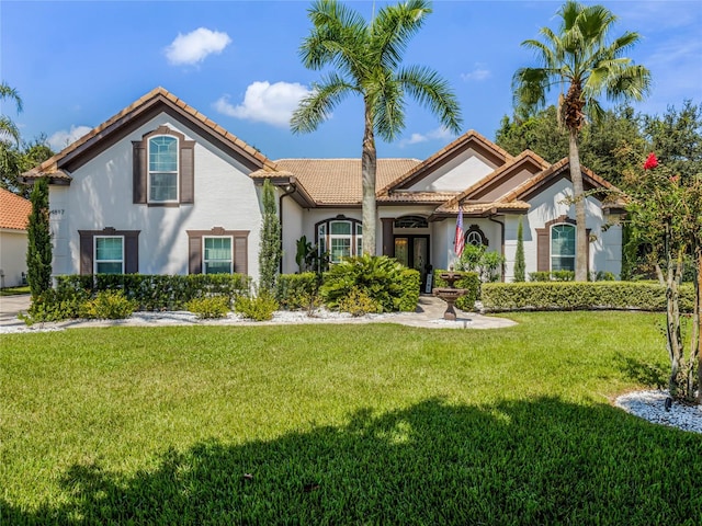 mediterranean / spanish house featuring a front yard