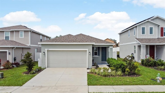 view of front of home featuring a front yard and a garage