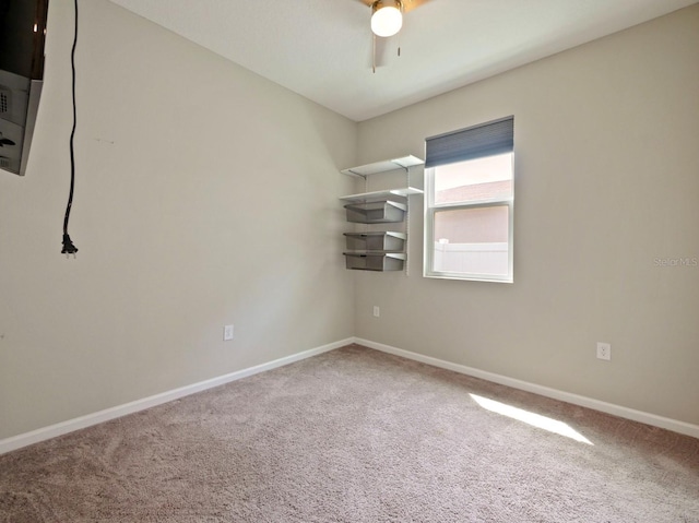 spare room featuring carpet and ceiling fan