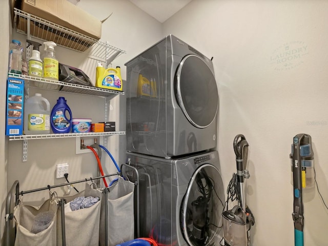 laundry area with stacked washing maching and dryer