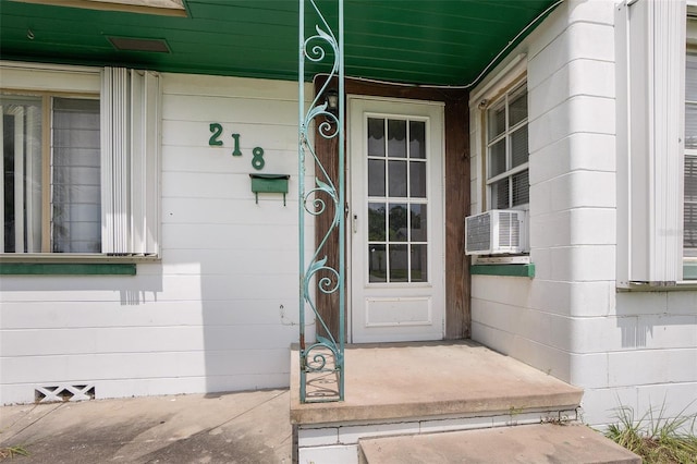 property entrance featuring cooling unit and a porch