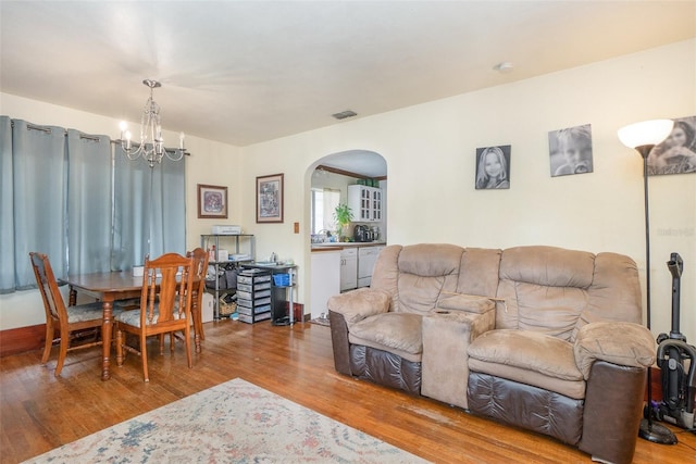 living room with wood-type flooring and a chandelier