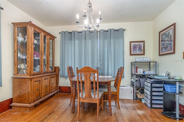 dining room featuring an inviting chandelier and hardwood / wood-style flooring