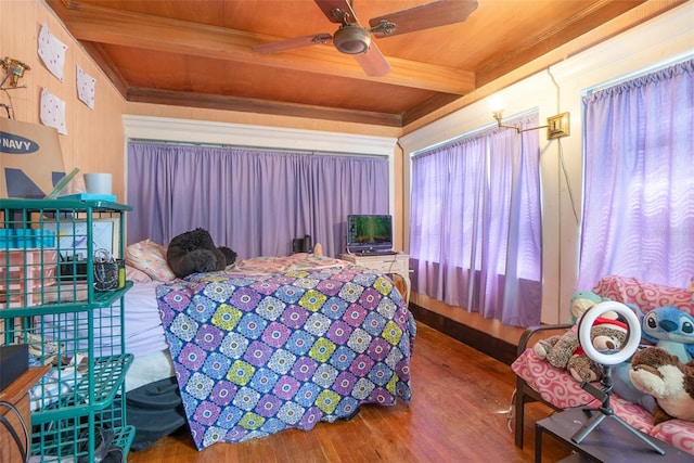 bedroom with wooden ceiling, beam ceiling, ceiling fan, and hardwood / wood-style flooring