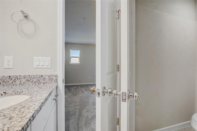 bathroom featuring vanity and toilet