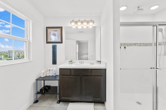 bathroom with tile patterned floors, a shower with door, and vanity