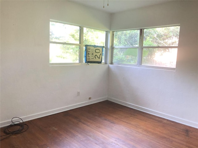 unfurnished room featuring dark hardwood / wood-style floors