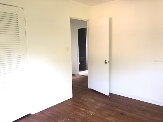 unfurnished bedroom featuring dark wood-type flooring