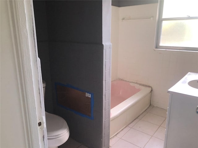 bathroom featuring vanity, tile walls, toilet, and tile patterned floors