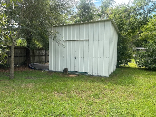 view of outbuilding featuring a lawn