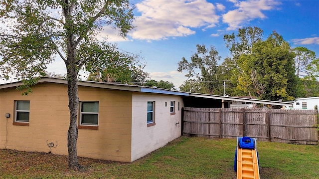 view of property exterior with a yard