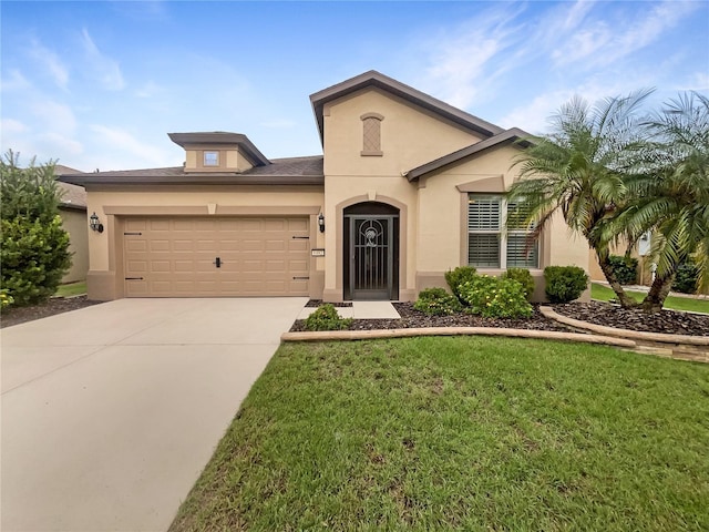 view of front of property with a front yard and a garage