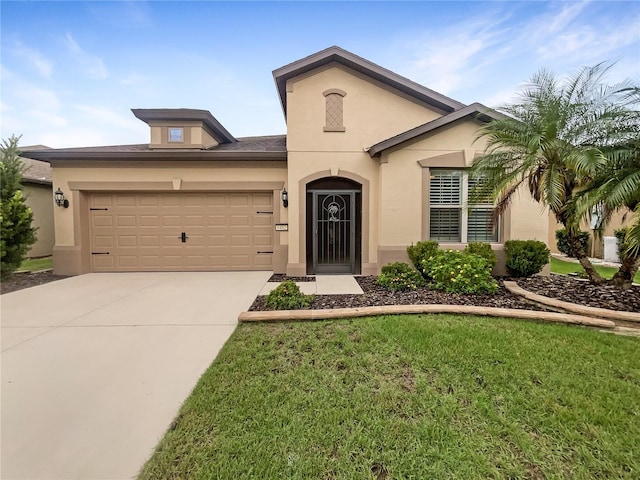 view of front of home featuring a front yard and a garage