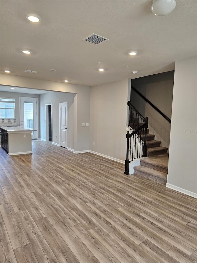 unfurnished living room with light hardwood / wood-style flooring