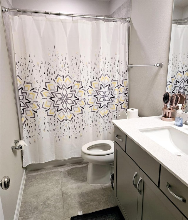 bathroom with walk in shower, vanity, toilet, and tile patterned floors