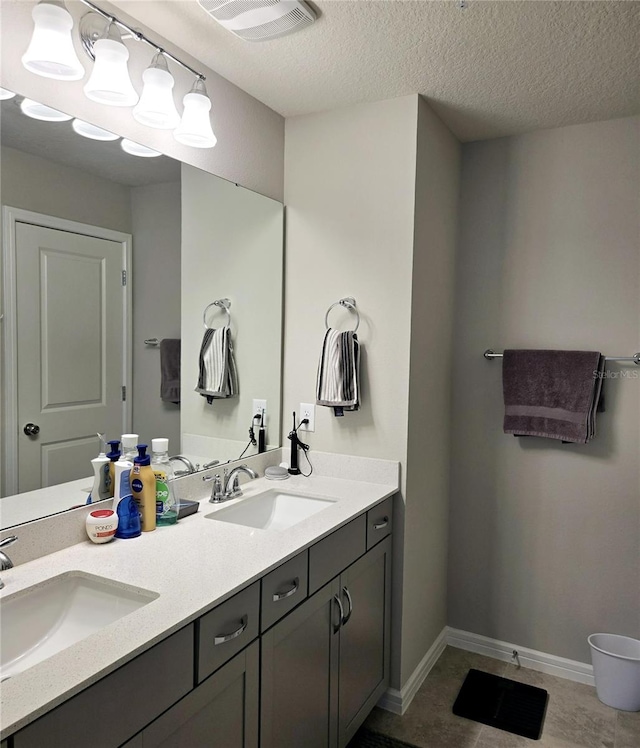 bathroom featuring vanity, a textured ceiling, and tile patterned floors