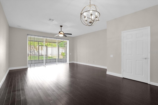 spare room featuring ceiling fan with notable chandelier and dark wood-type flooring