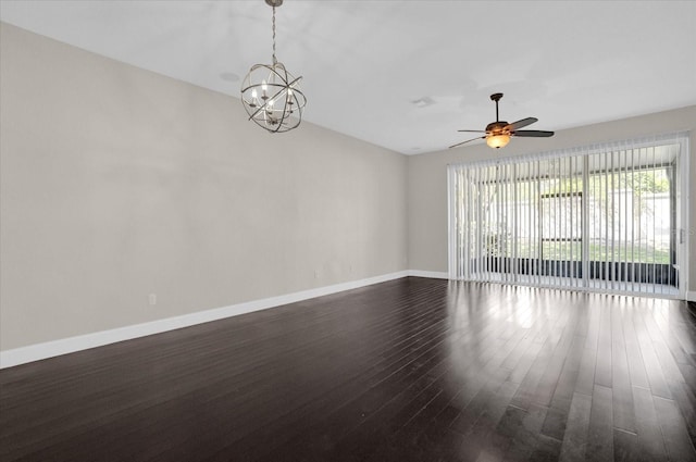 unfurnished room with ceiling fan with notable chandelier and dark wood-type flooring