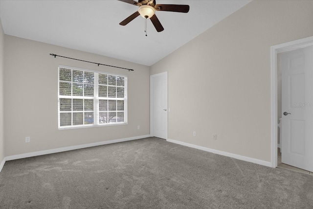 empty room with carpet flooring, vaulted ceiling, and ceiling fan