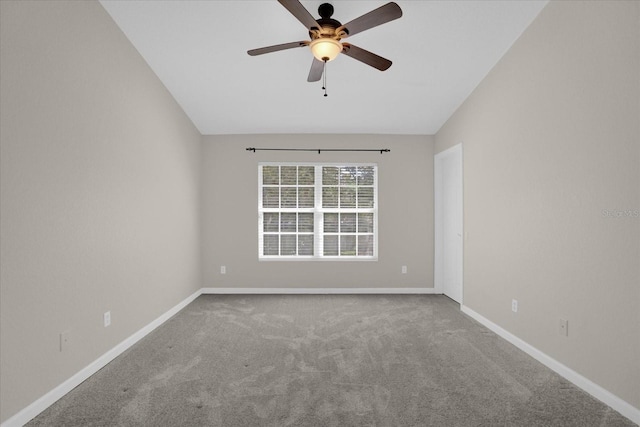 spare room featuring vaulted ceiling, ceiling fan, and carpet flooring