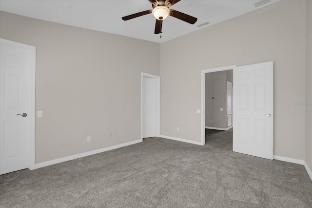 carpeted spare room featuring ceiling fan