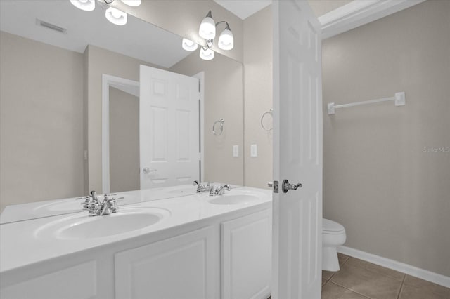 bathroom featuring vanity, toilet, and tile patterned floors