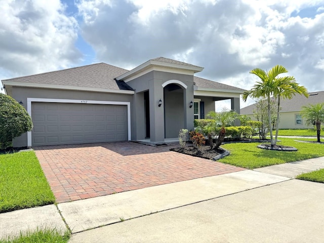 view of front of property featuring a front yard and a garage