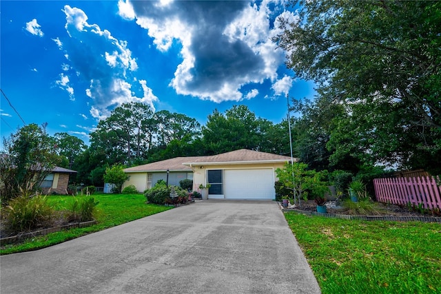 ranch-style home featuring a garage and a front lawn