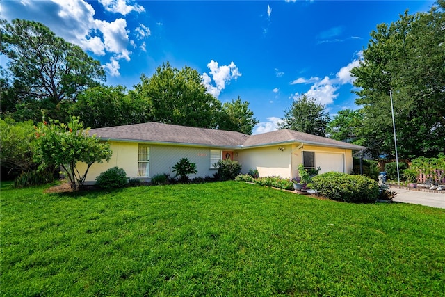 ranch-style home with a garage and a front yard