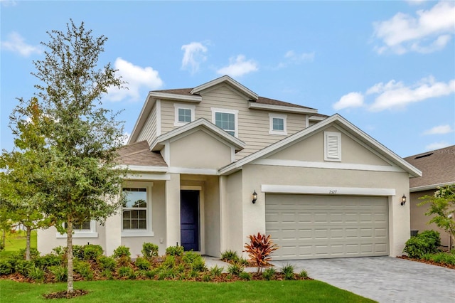 view of front of home with a garage and a front lawn