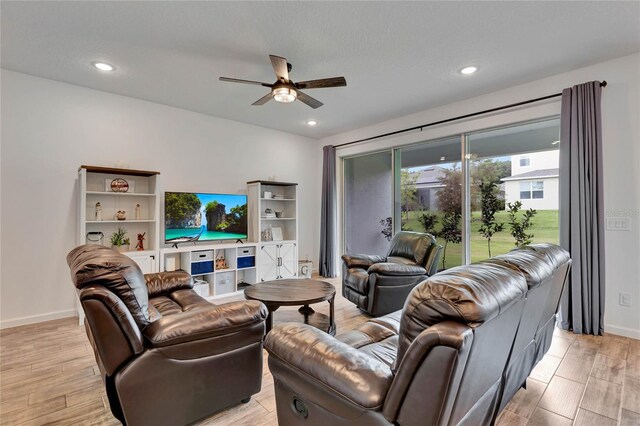 living room featuring light wood-type flooring and ceiling fan