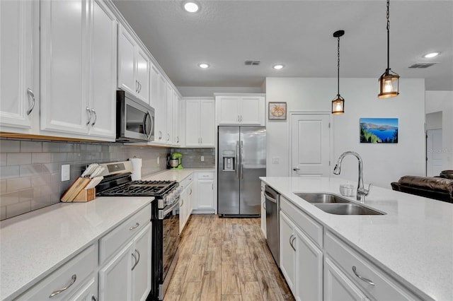 kitchen with white cabinetry, appliances with stainless steel finishes, and sink